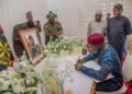 *Lt-Gen TY Buratai (seated), signing the Condolence register at the residence of the late  COAS, Lt-Gen Taoreed Lagbaja